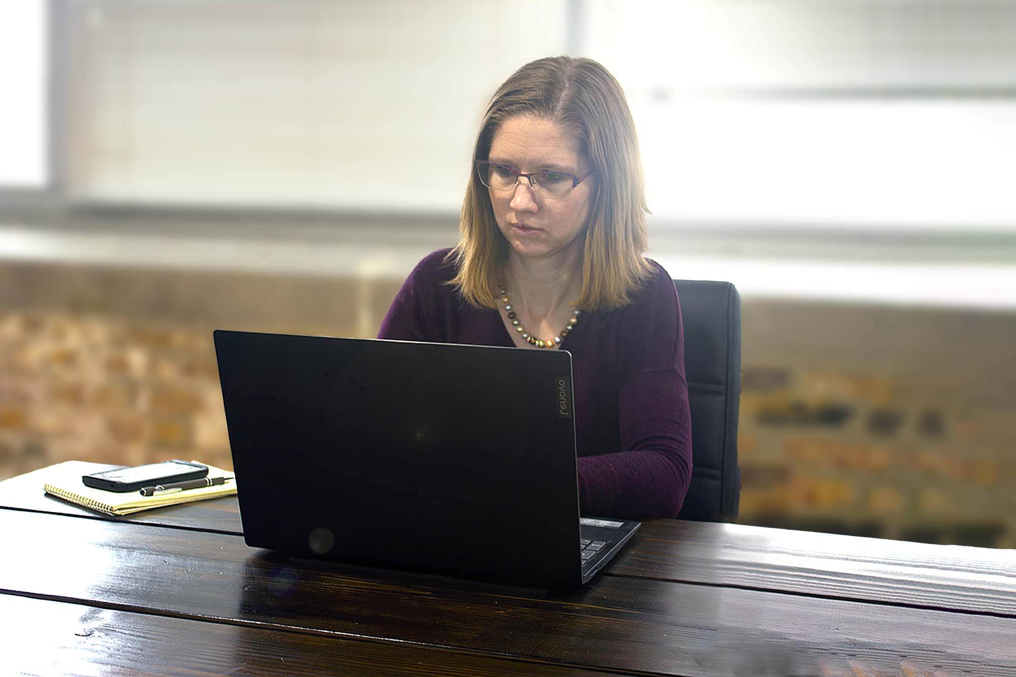 Photo of attorney Jennifer Brugh working on her computer